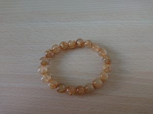 Rutilated Quartz Meaning: Money Luck, Decisiveness, and the Golden Needle Power Stone